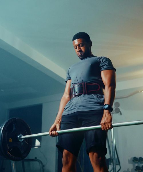 Athlete holding a kettlebell, demonstrating balance and core strength.